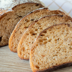 Sliced artisanal sourdough bread on board