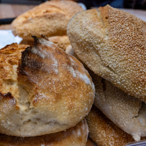Crusty sourdough and sesame bread rolls
